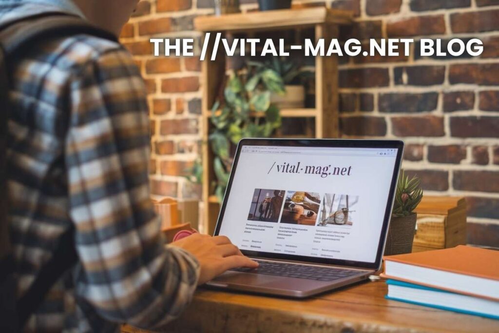 Laptop displaying the vital-mag.net blog homepage, accompanied by an open book and potted plants in the background.