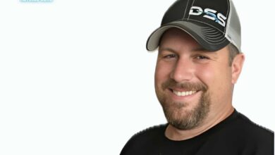 A smiling Brad Dummer wearing a black cap with the 'DSS' logo, remembered fondly in his obituary from Pecatonica, IL.