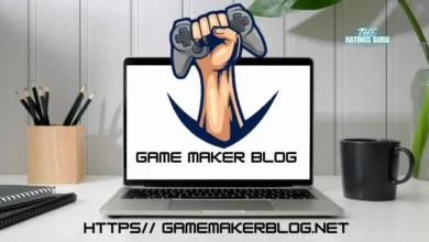 Game Maker Blog logo featuring a raised fist holding a gaming controller displayed on a laptop screen, placed on a desk with a notebook, plant, and coffee mug in the background. The URL https// gamemakerblog.net is shown at the bottom of the image