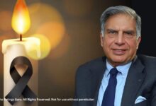 Image of Ratan Tata, dressed in a suit, alongside a lit candle with a black ribbon symbolizing mourning, related to Ratan Tata passed away.